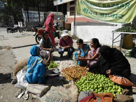 Sarah Elton interviewing women at an organic bazaar in India