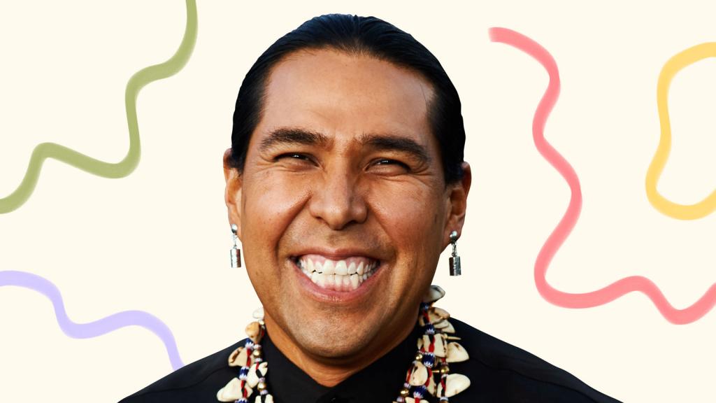 Dallas Goldtooth smiling surrounded by illustrated waves of color
