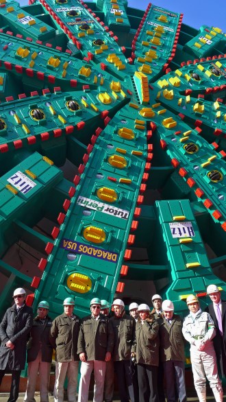 SR 99 Tunnel Project leaders pose in front of Bertha, the world’s largest-diameter tunneling machine, in December 2012.