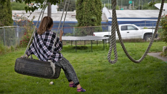 Lahrman's daughter Holland, 12, swings on the tire swing. 