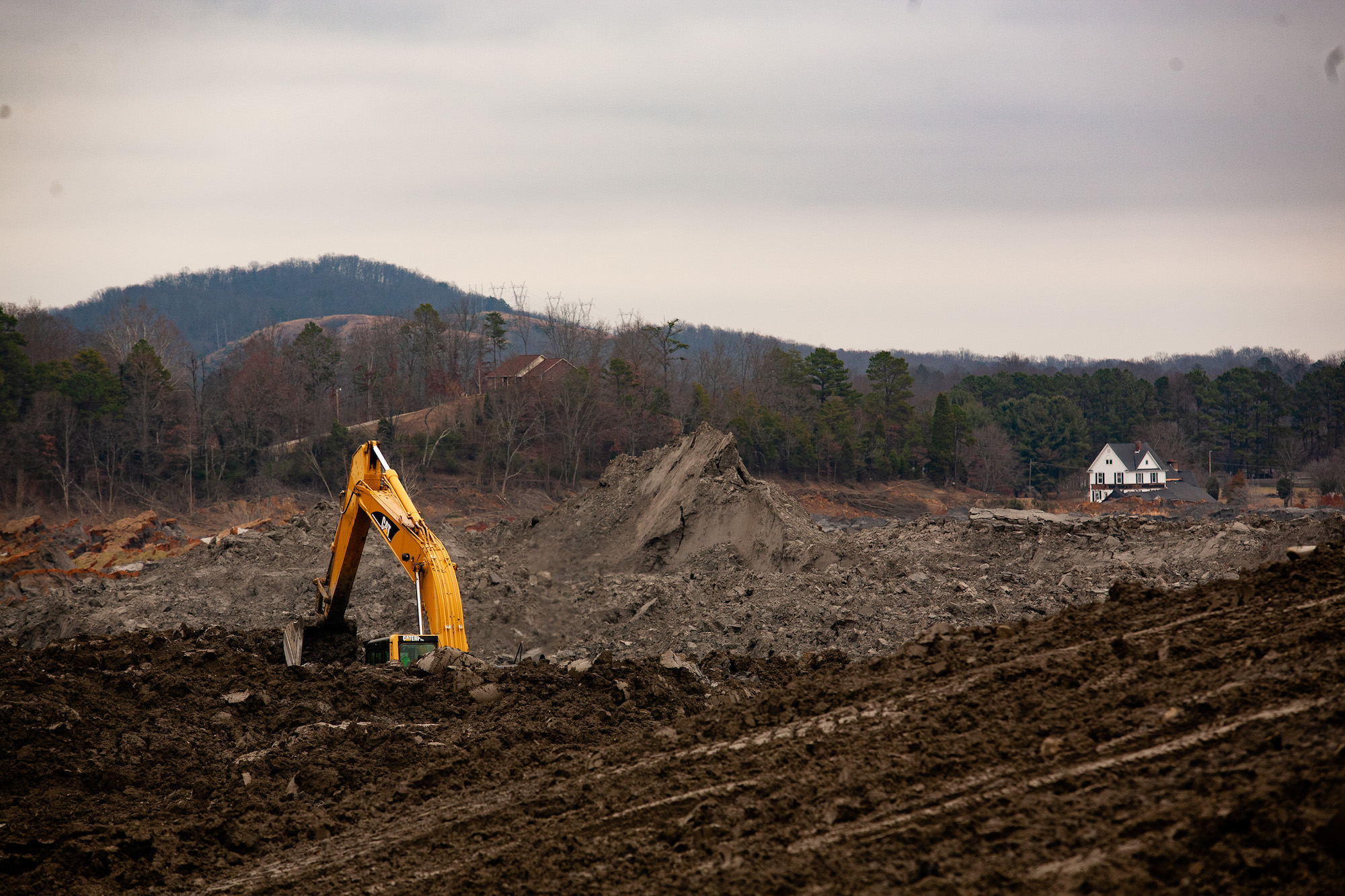 A house overlooks coal fly ash slurry released from the TVA’s Kingston Fossil Plant.