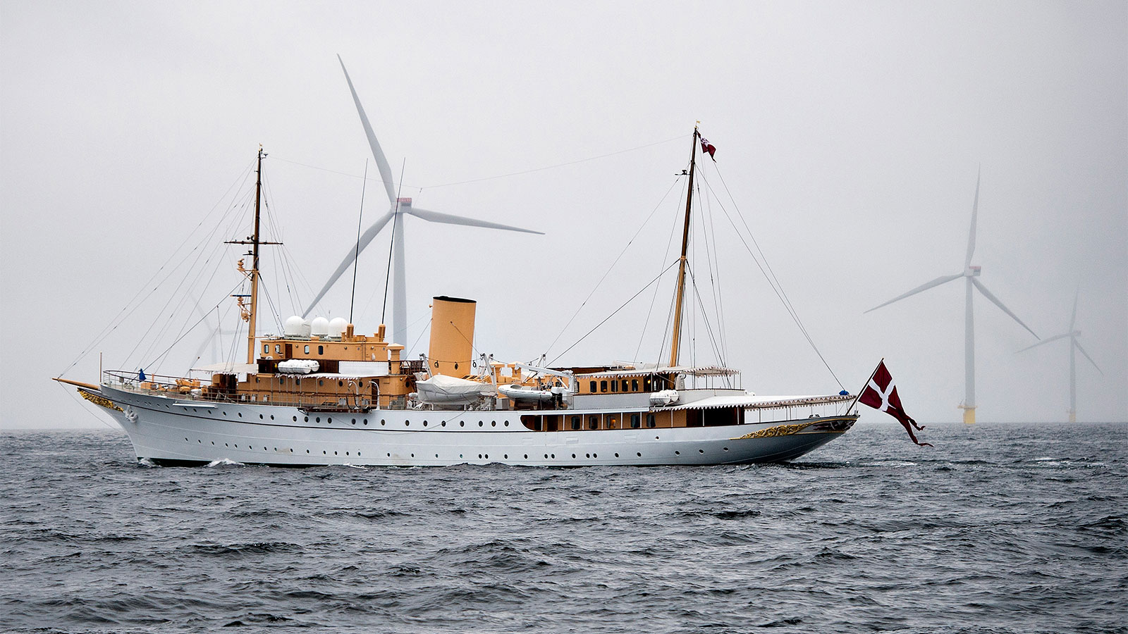 The Royal Danish Yacht passes by Denmark's largest offshore wind farm off of Anholt Island