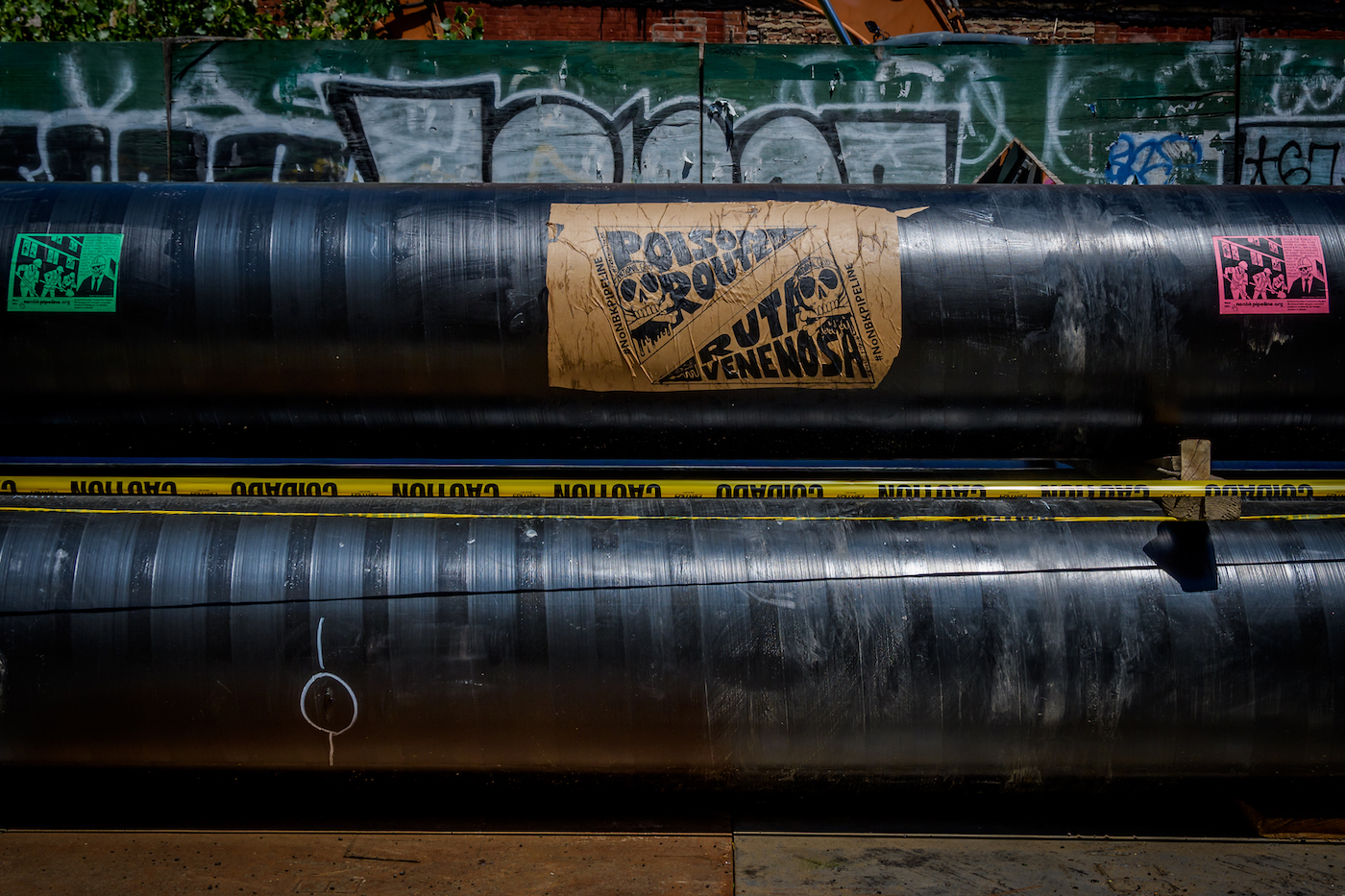 a pipeline with a protest sign glued to it