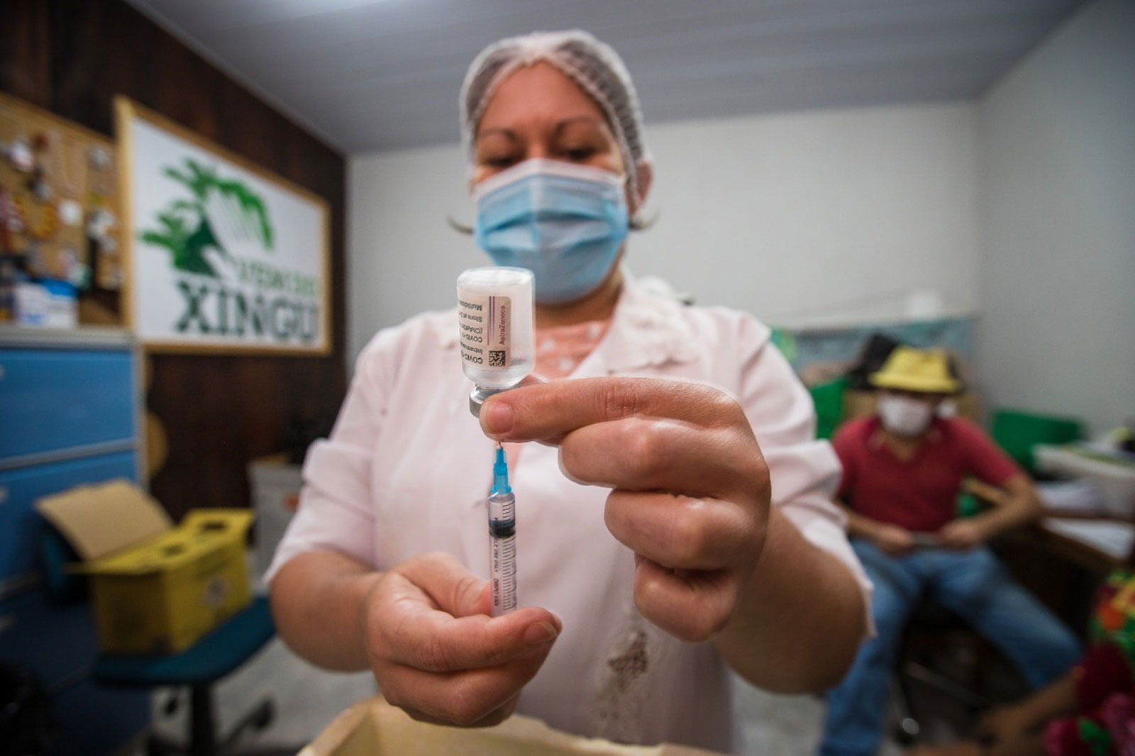 A nurse filling a syringe with the COVID-19 vaccine