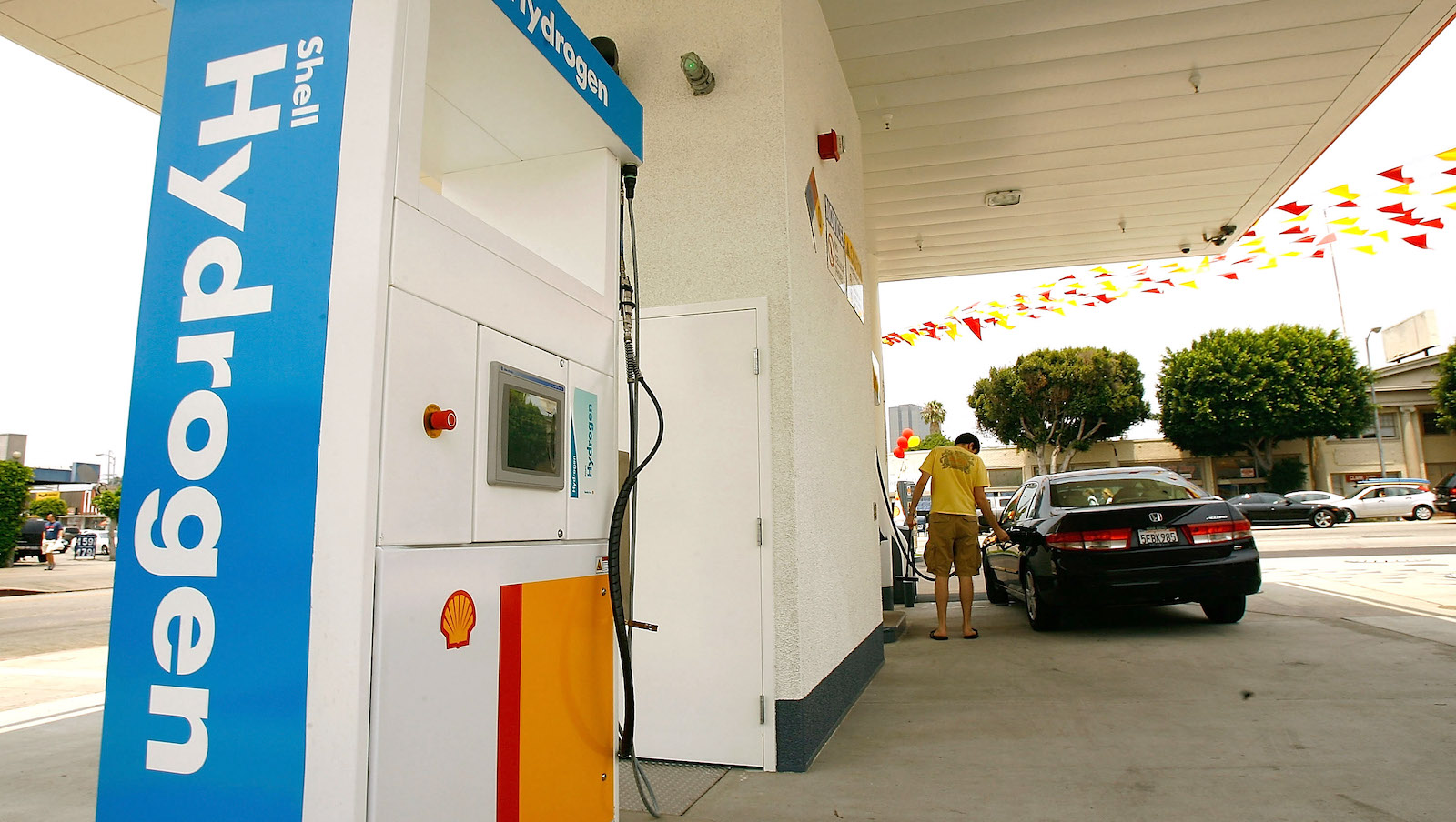 A man fills his car at a hydrogen fueling station in Los Angeles.