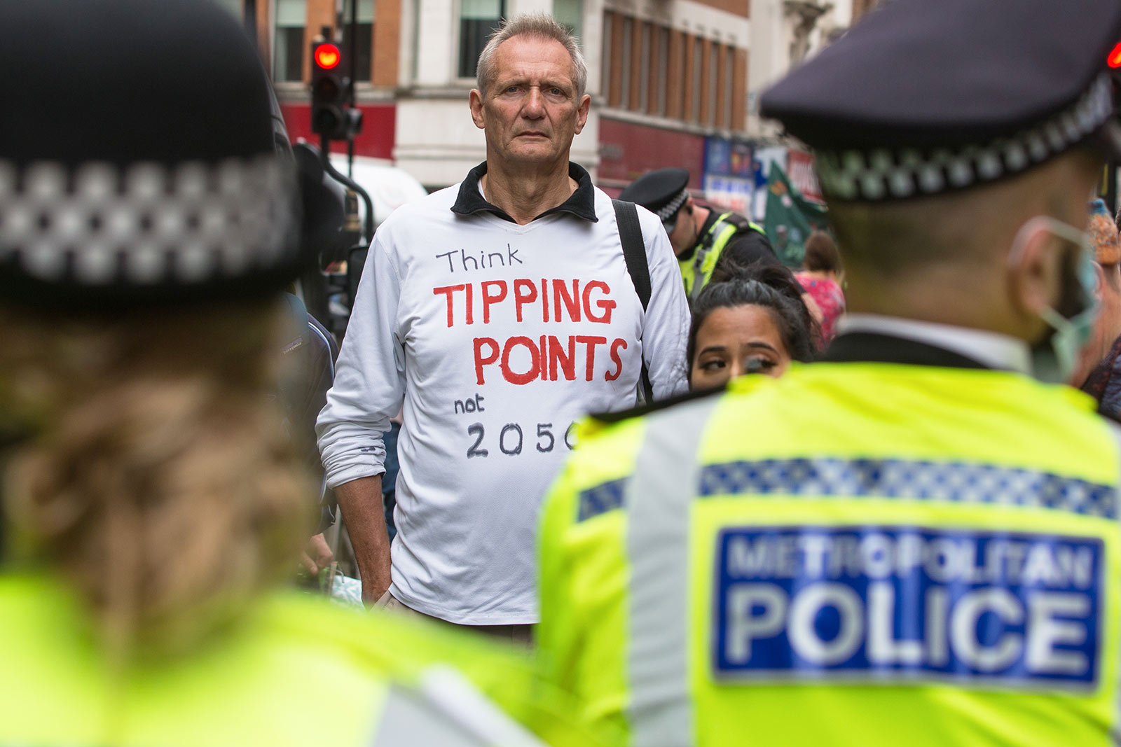 An environmental activist from Extinction Rebellion wears a t-shirt referring to climate tipping points
