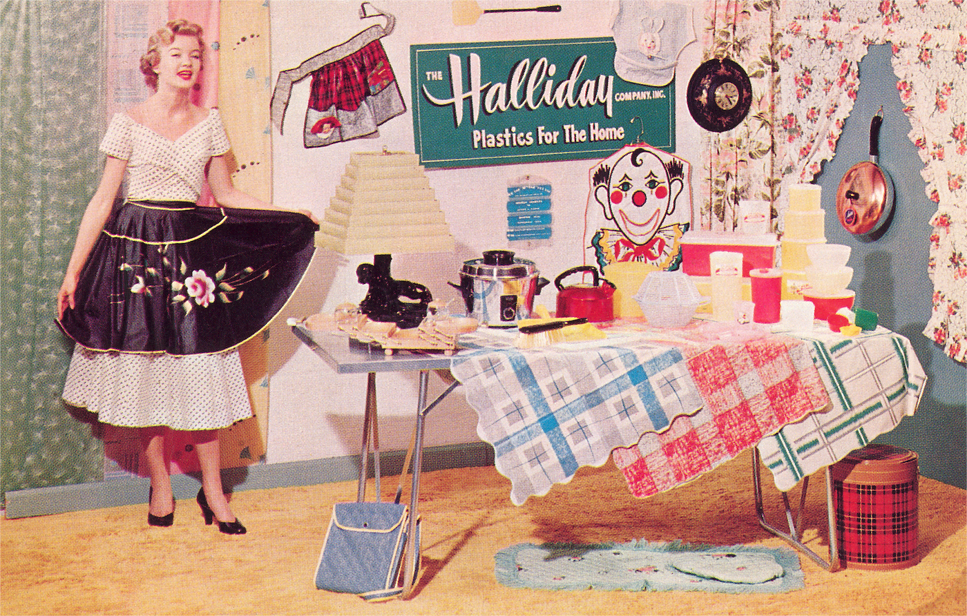 An old-fashioned display of household items like containers, tablecloths, and signs made from plastic.