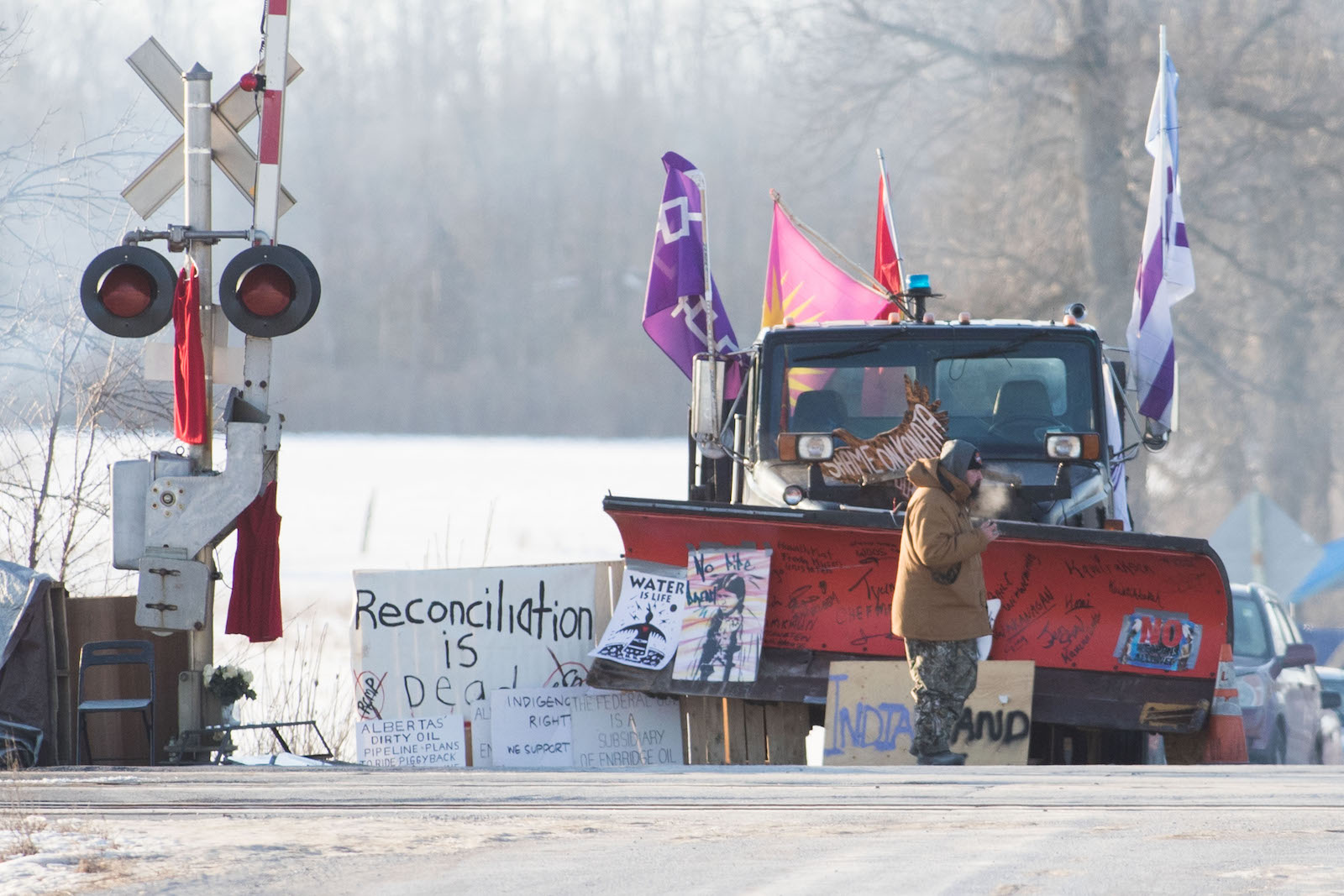 bulldozer and protest signs blocking railroad tracks