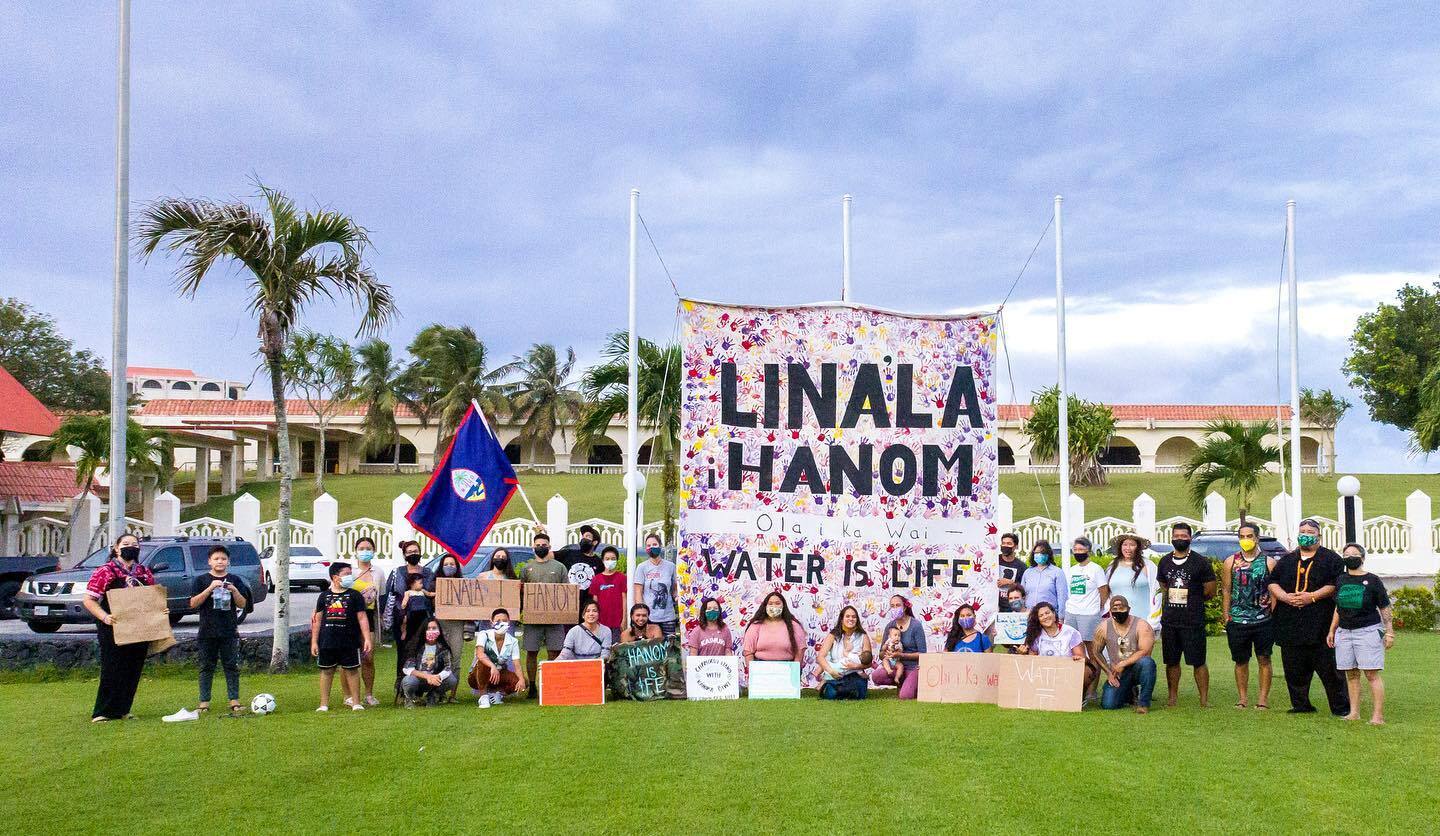 Large group of people holding protest signs with a large sign reading "Linala Hanom; Water is Life"