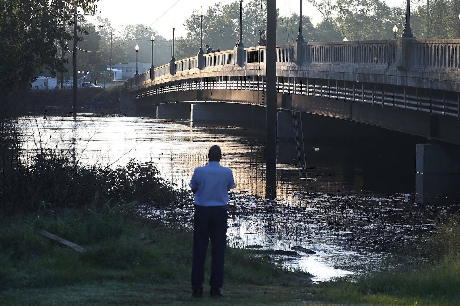People look on at the Cape Fear river as it crests from the rains caused by Hurricane Florence on September 18, 2018.