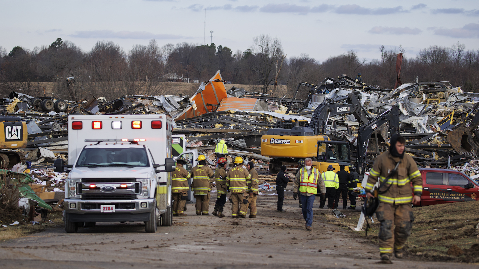 Emergency crews search through the flattened Mayfield Consumer Products building on December 11, 2021 in Mayfield, Kentucky.