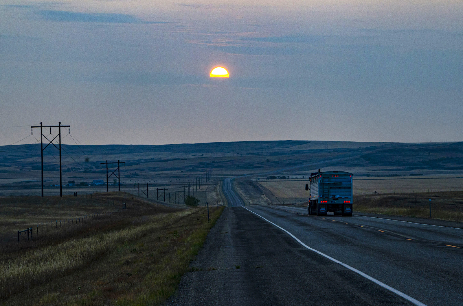 Wildfire smoke obscures the sunrise near Wolf Point, Fort Peck Indian Reservation, Montana. Wolf Point’s community “rural capacity” score is 52/100, lower than the state median of 58.