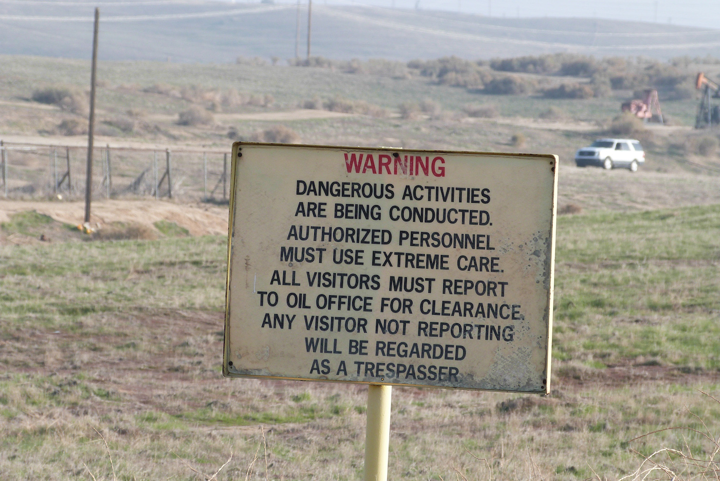 Warning sign at the Poso Creek Oil Field, north of Bakersfield in Kern County.