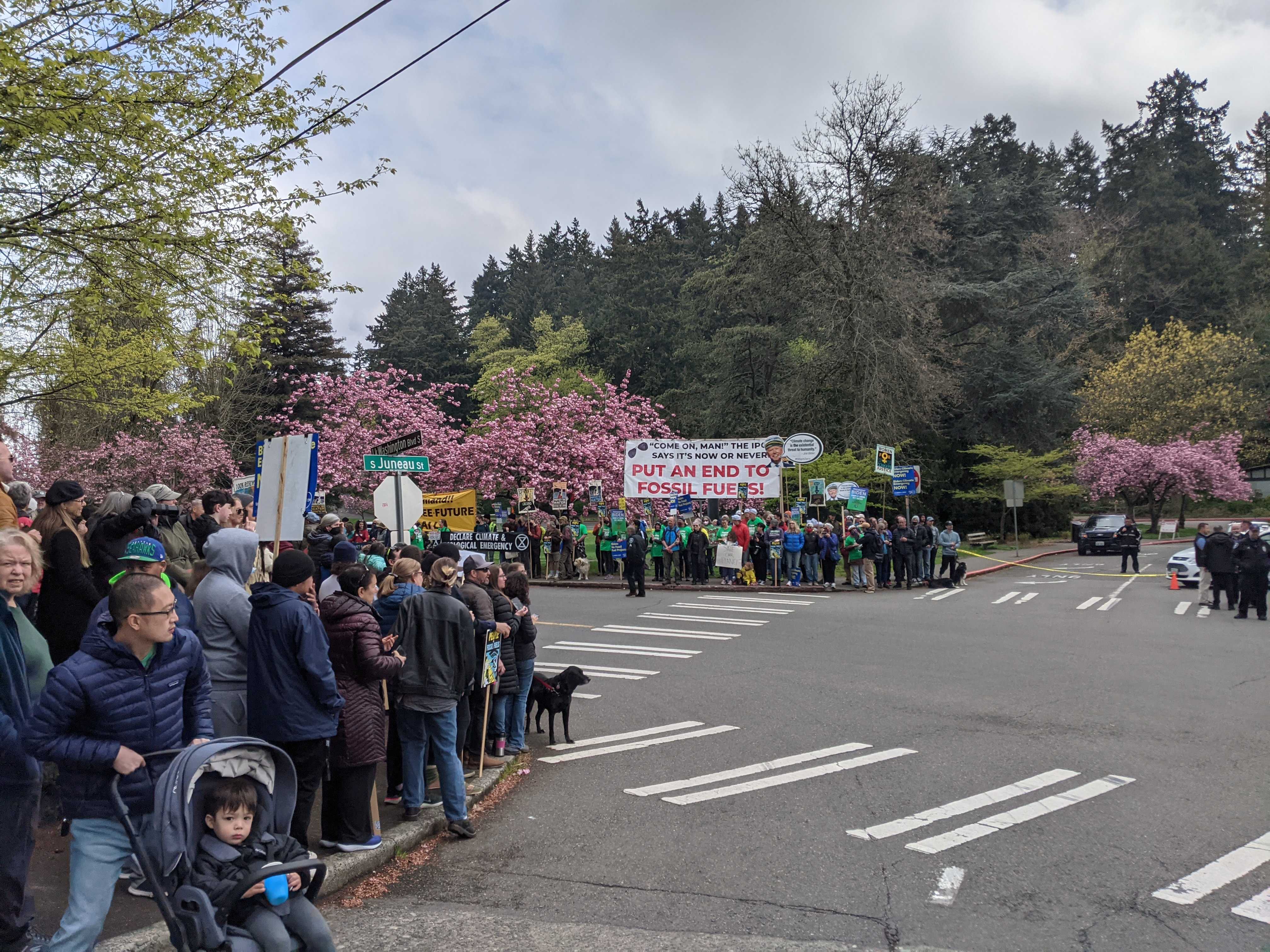 Protesters outside Seward Park call for an end to fossil fuel development ahead of President Joe Biden's Earth Day address.