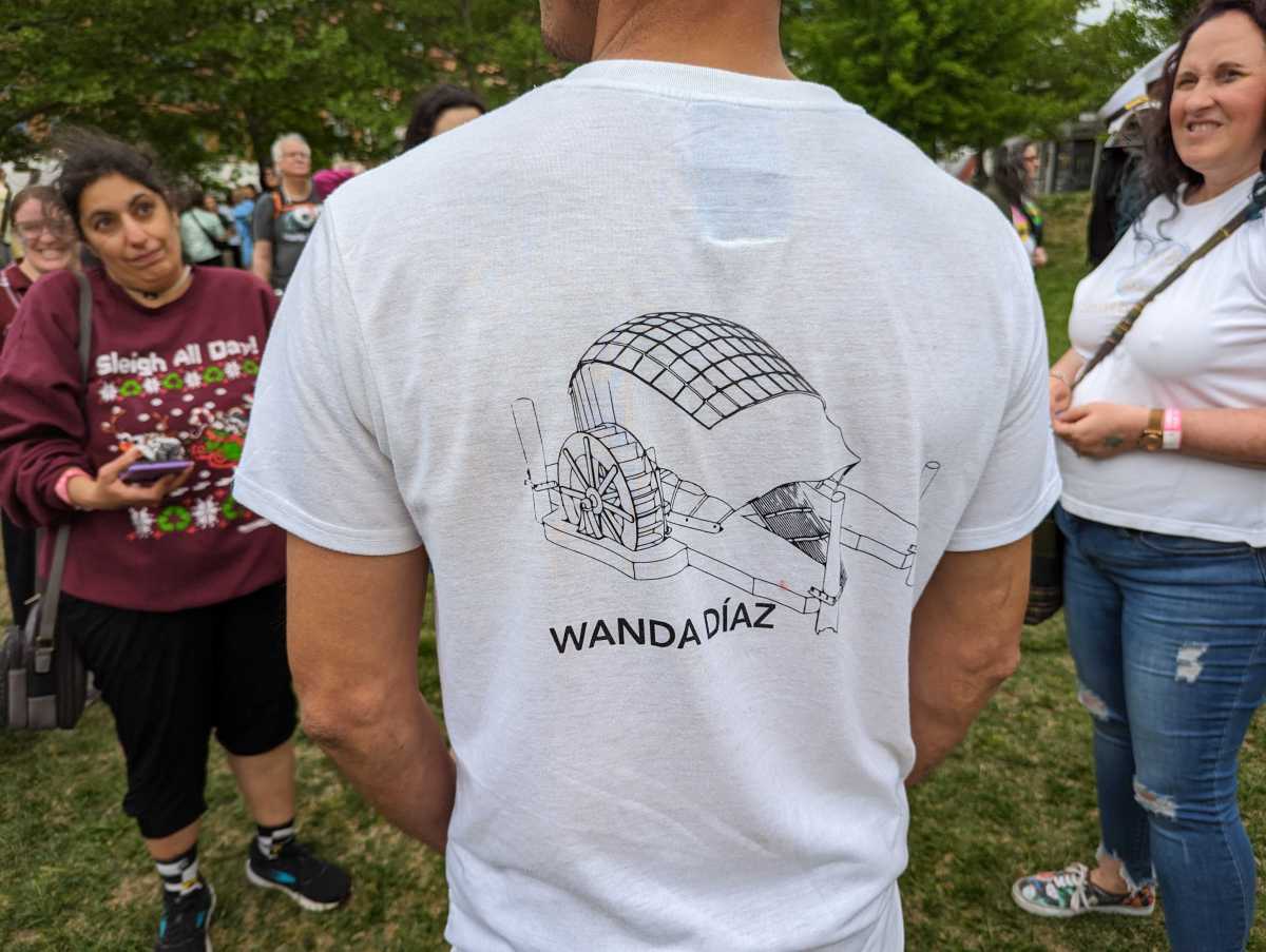 The back of a T-shirt showing Wanda Díaz, the new Panamanian trash wheel.
