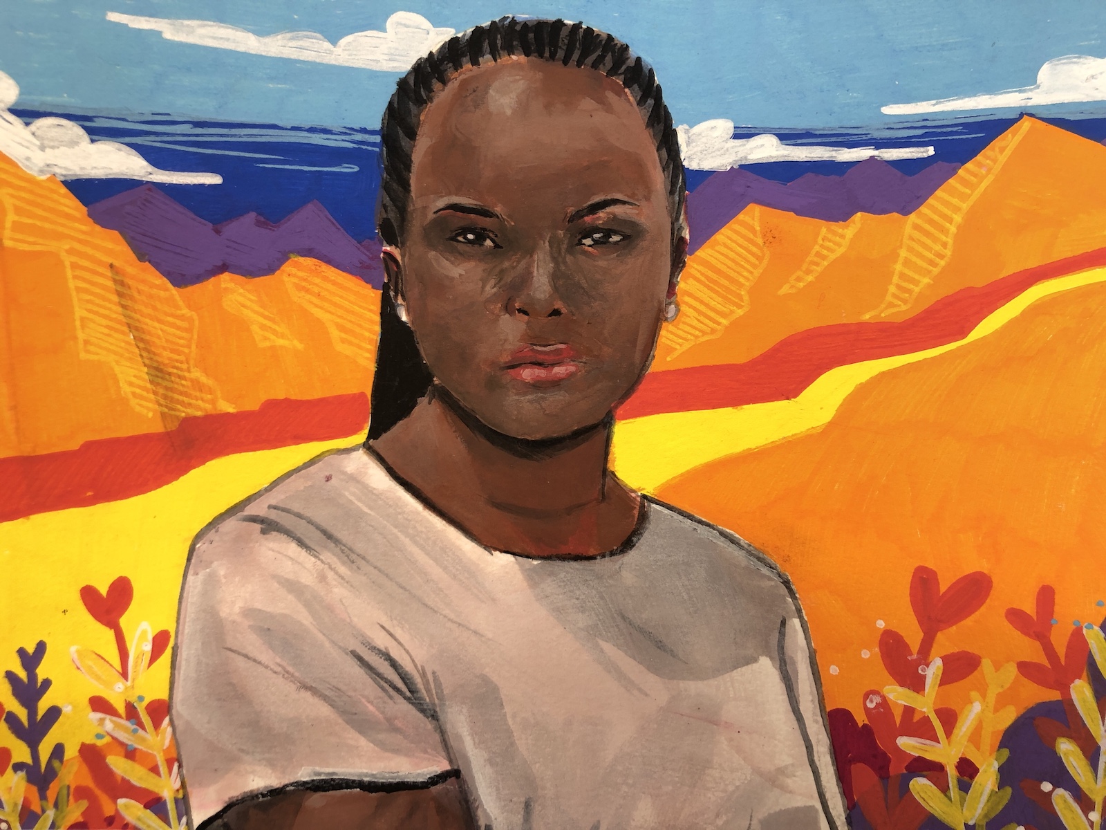 a young black woman in front of orange mountains