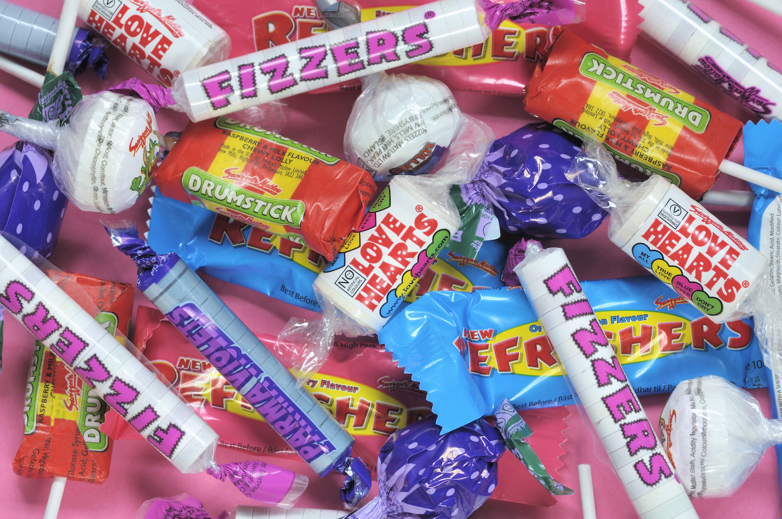 a bunch of candy with plastic wrappers