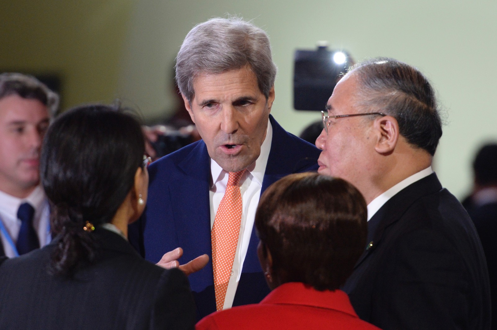 Former U.S. Secretary of State John Kerry speaks with delegates at COP21 in Le Bourget, north of Paris, on December 12, 2015.